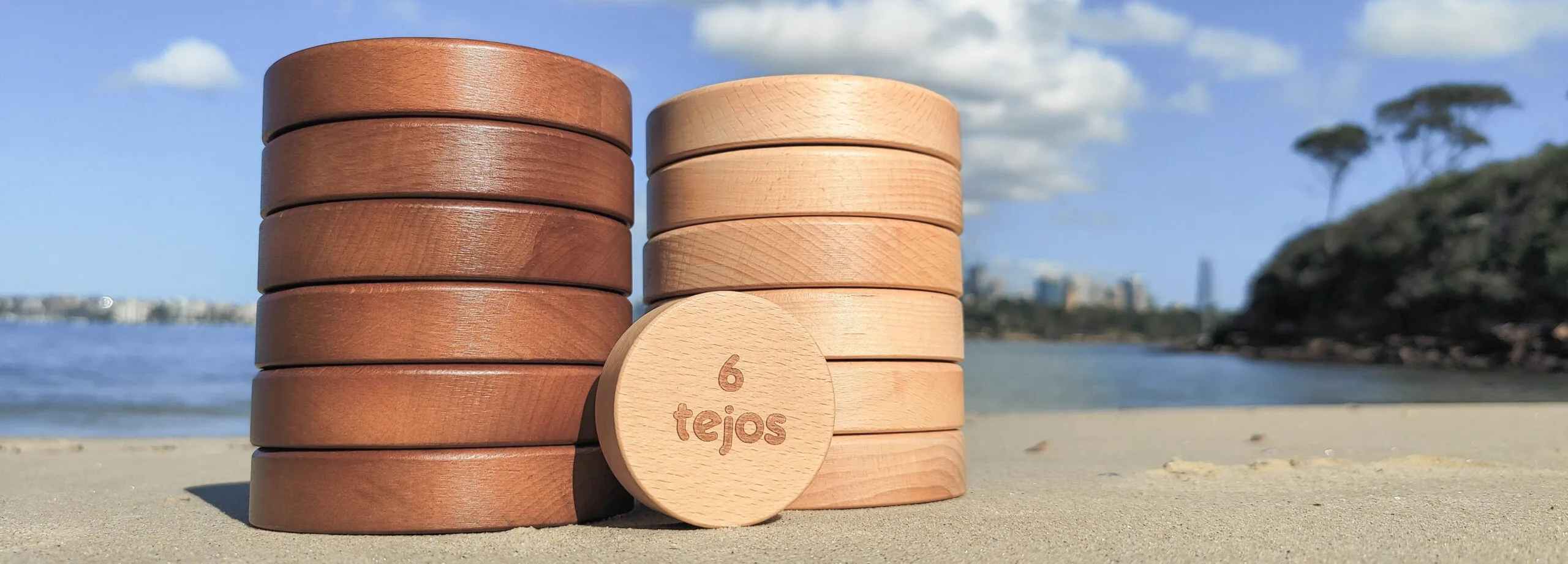Wooden tejos set on the beach with water in the background